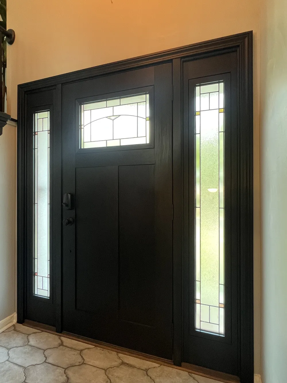 New black fiberglass entry door with glass sidelights installed on an Elmhurst, Illinois home
